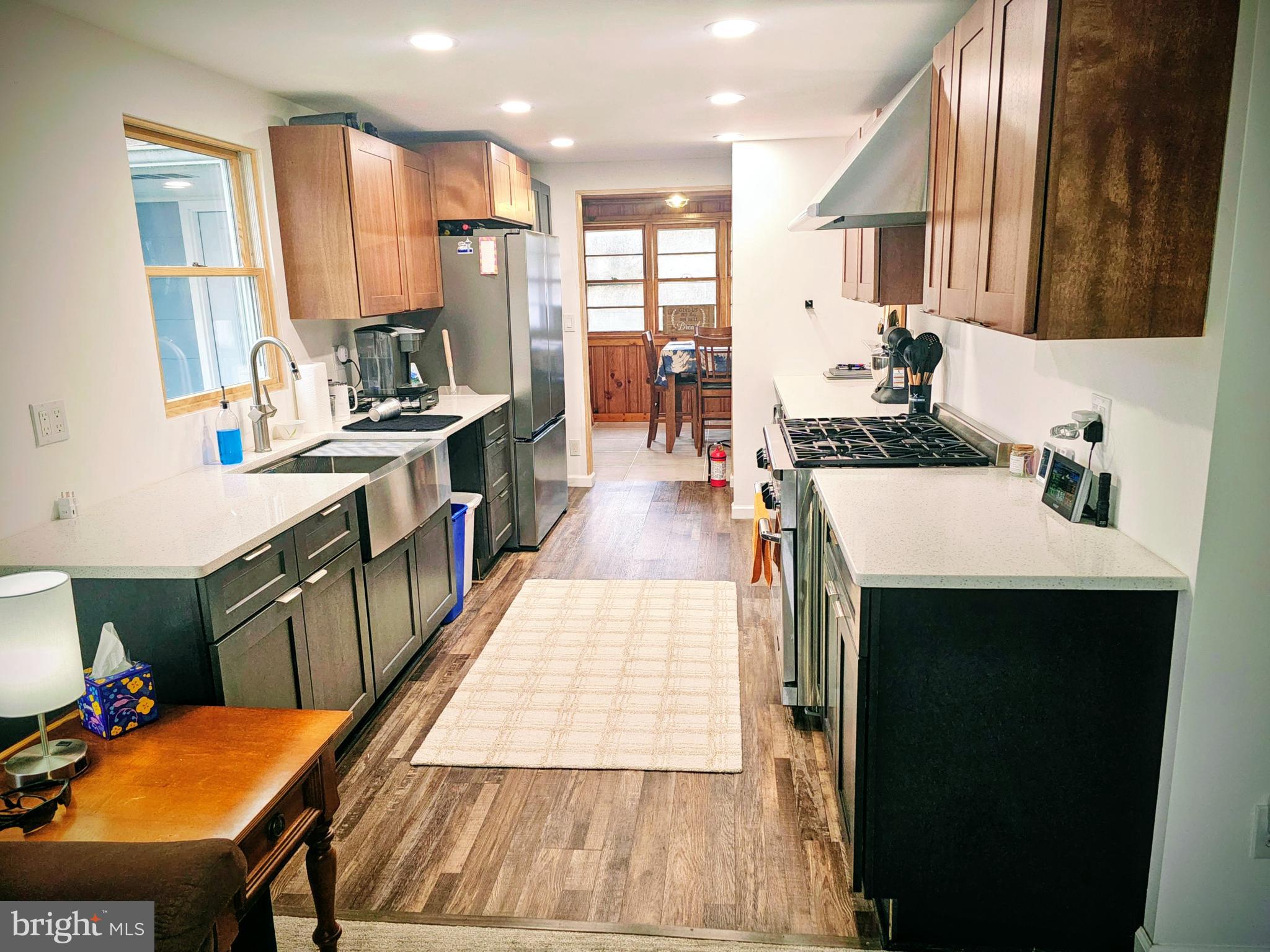2891 Union Road Vineland, NJ 08361 - Photo 7 of 25 a kitchen with stainless steel appliances kitchen island granite countertop a table chairs in it and wooden floors