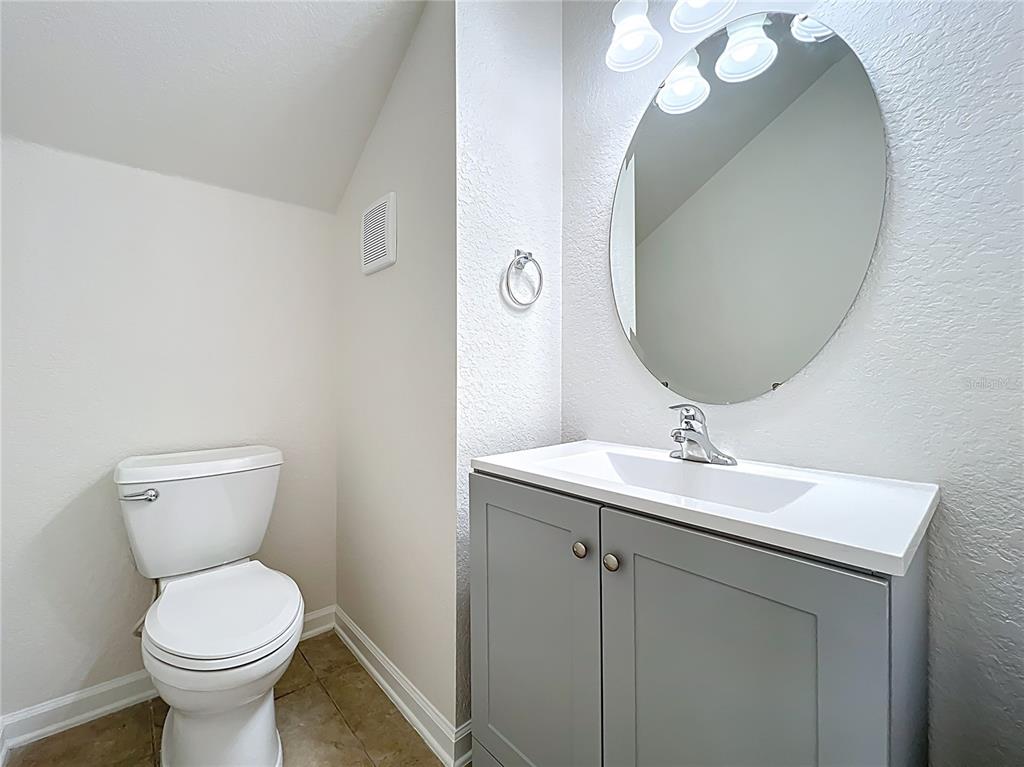 12930 Vennetta Way Windermere, FL 34786 - Photo 15 of 38 a bathroom with a toilet a sink and mirror