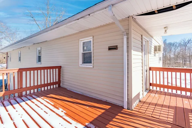 a view of a balcony with wooden floor