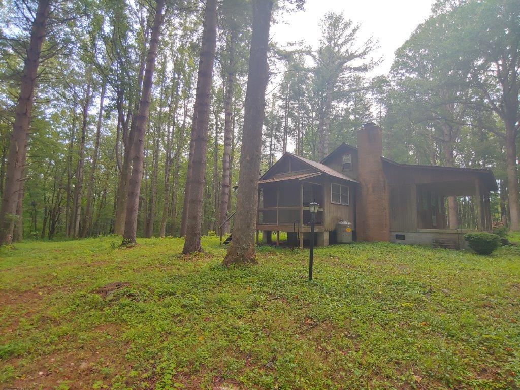 1123 Silverleaf Road Southeast Floyd, VA 24091 - Photo 11 of 13 a backyard of a house with lots of green space and fountain