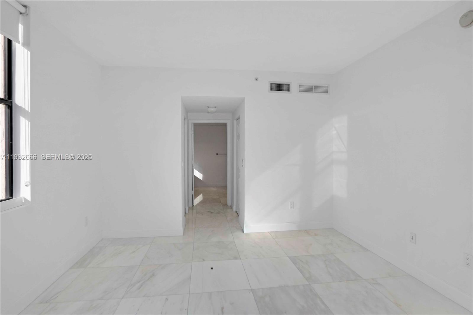 888 Douglas Road, Unit 1203 Coral Gables, FL 33134 - Photo 19 of 27 a view of a room with a hallway