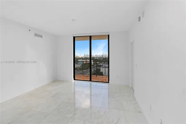 a view of an empty room with glass door