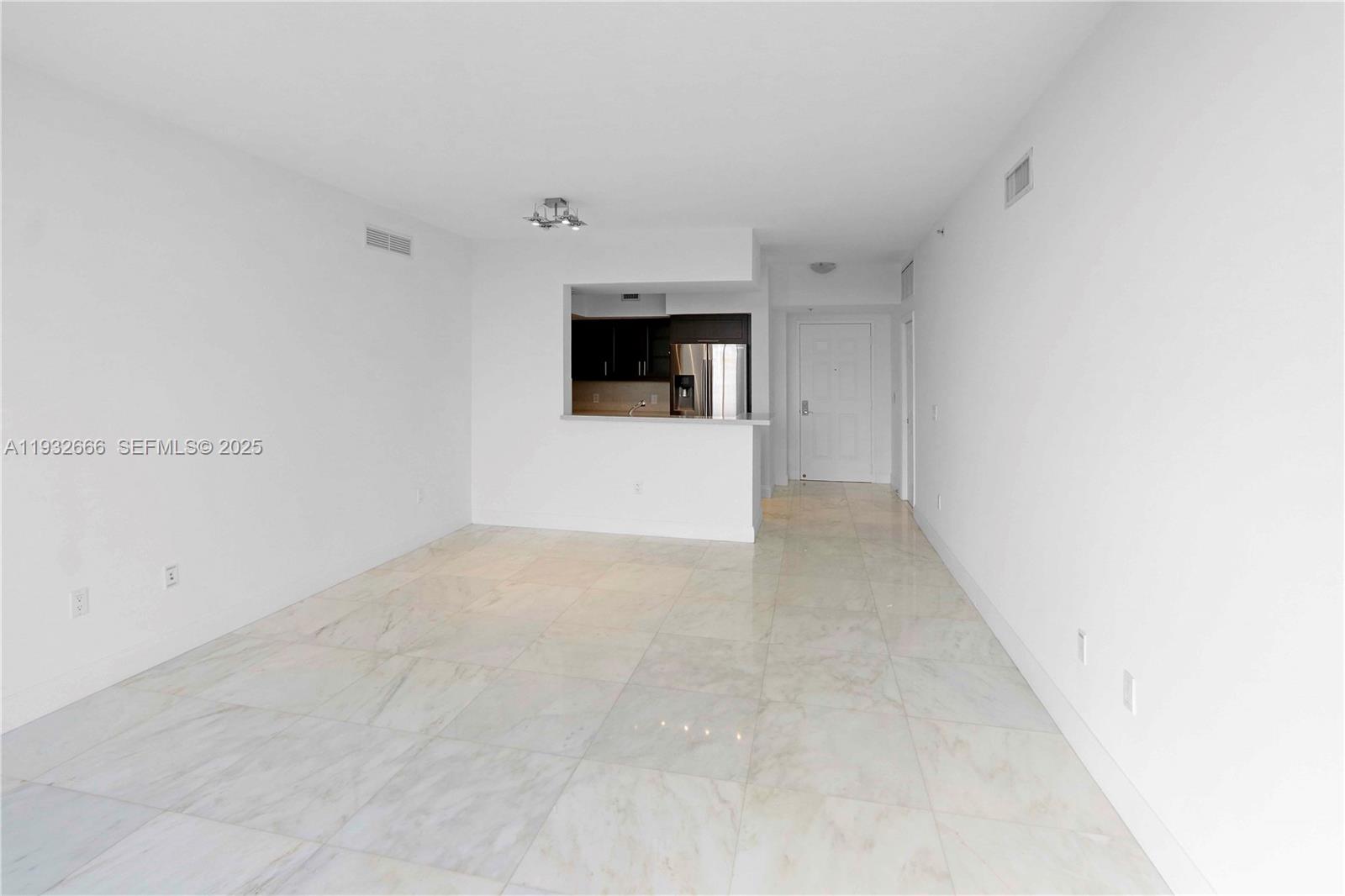 888 Douglas Road, Unit 1203 Coral Gables, FL 33134 - Photo 8 of 27 a view of a big room with wooden floor and window