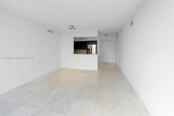 a view of a big room with wooden floor and window