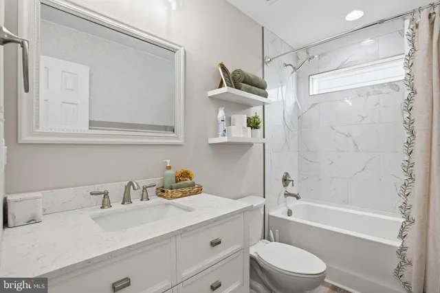 a utility room with wooden floor washer and dryer