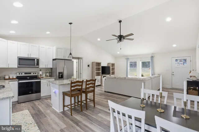 a kitchen with stainless steel appliances granite countertop a sink refrigerator and microwave