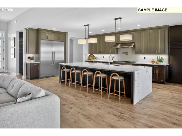 a kitchen with stainless steel appliances granite countertop a refrigerator a sink dishwasher a stove and a cabinets