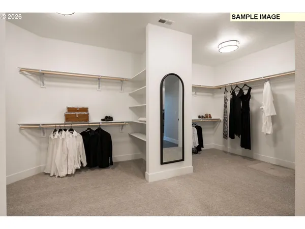 a living room with furniture a mirror and white walls