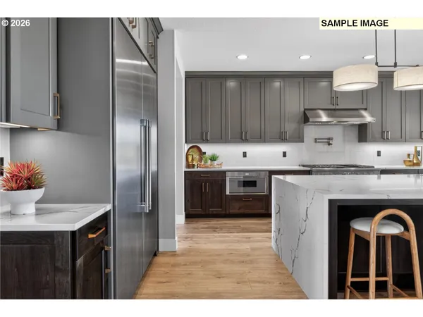 a kitchen with stainless steel appliances granite countertop a sink and cabinets