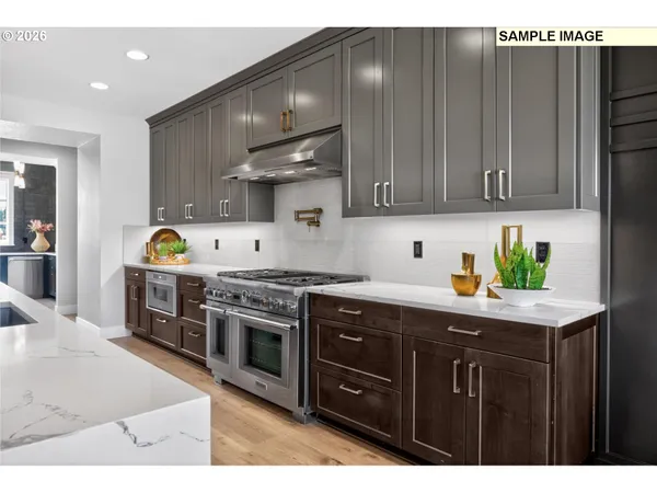 a kitchen with stainless steel appliances granite countertop a stove a sink and a microwave