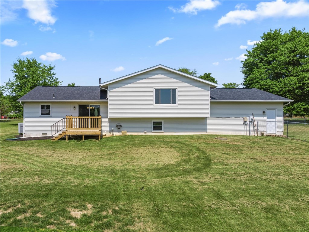 1353 Foust Road Xenia, OH 45385 - Photo 23 of 50 The home features a well-maintained yard and a wooden deck, perfect for outdoor enjoyment.