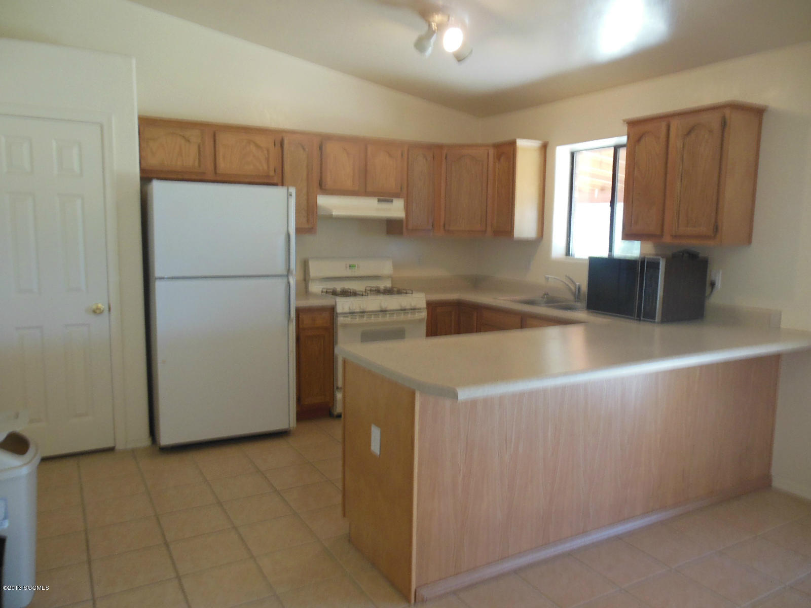 284 Círculo Silva Rio Rico, AZ 85648 - Photo 3 of 19 a kitchen with a refrigerator a sink and cabinets