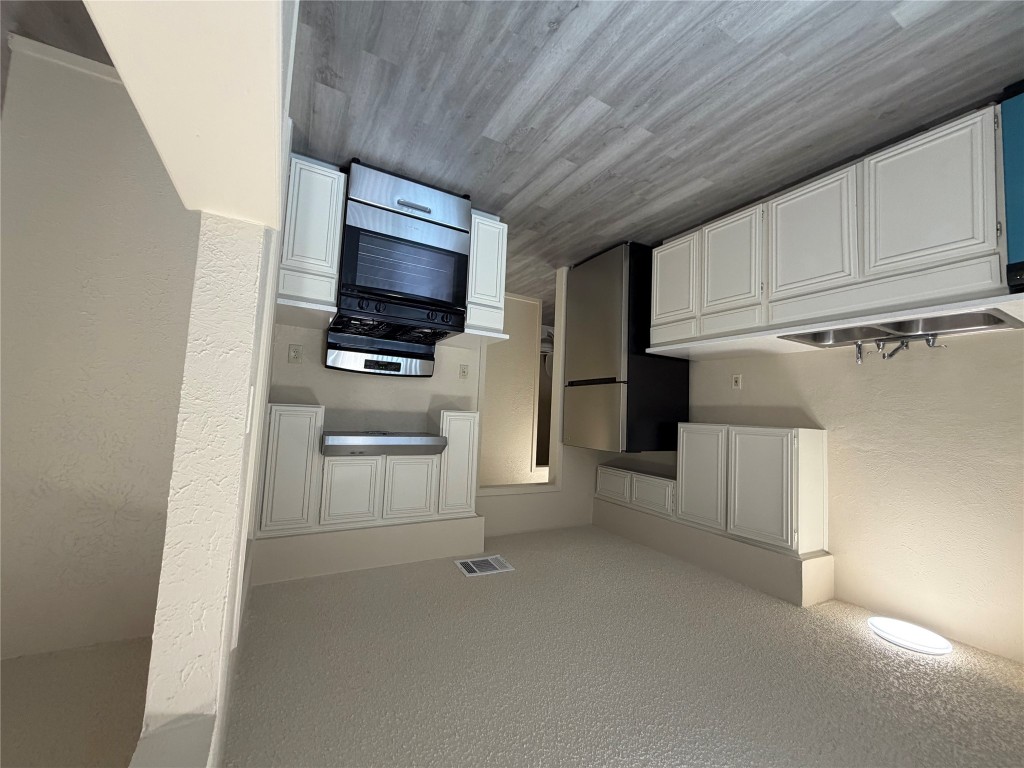 2400 Berkeley Avenue, Unit B Austin, TX 78745 - Photo 11 of 18 a kitchen with granite countertop a refrigerator stove top oven and sink