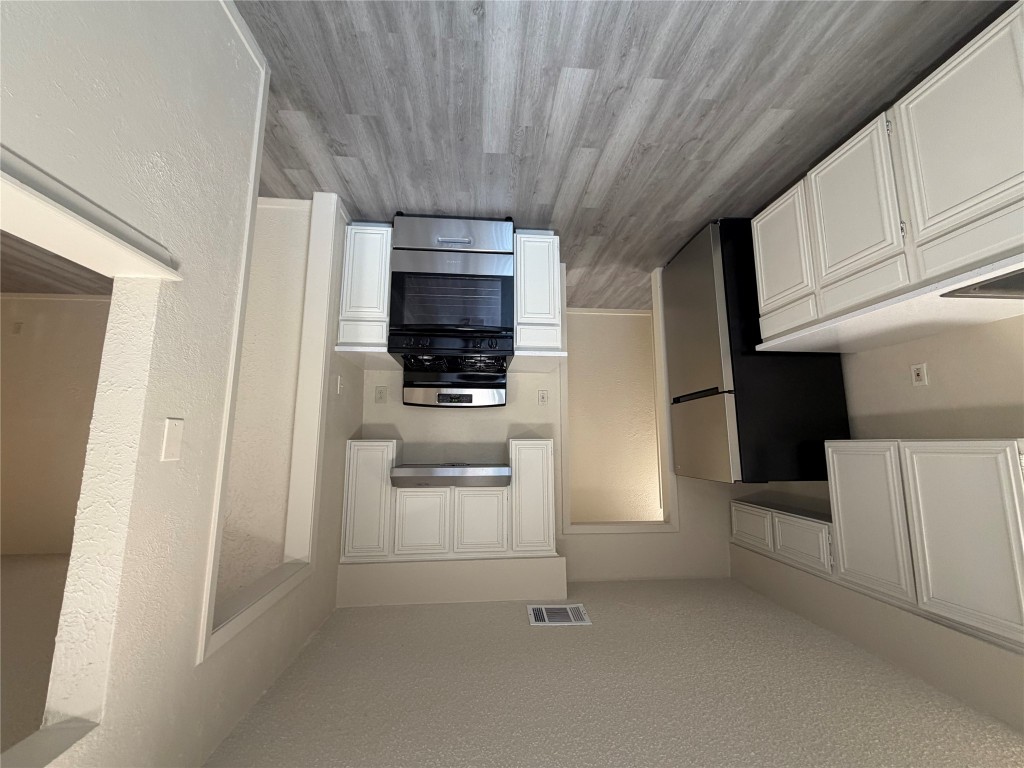 2400 Berkeley Avenue, Unit B Austin, TX 78745 - Photo 12 of 18 a kitchen with a refrigerator and a stove top oven