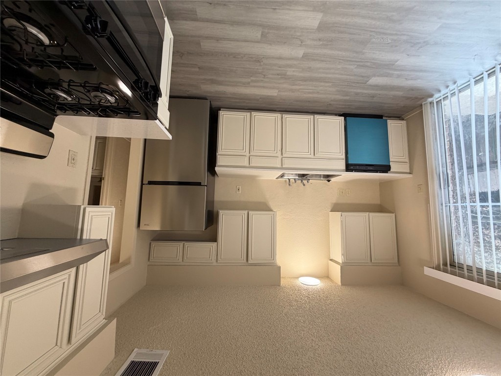 2400 Berkeley Avenue, Unit B Austin, TX 78745 - Photo 14 of 18 a kitchen with a stove a refrigerator and a sink