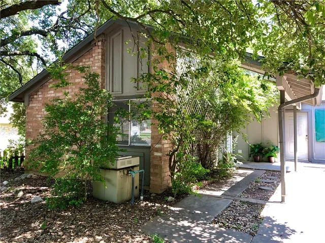 a view of a brick house with a glass door