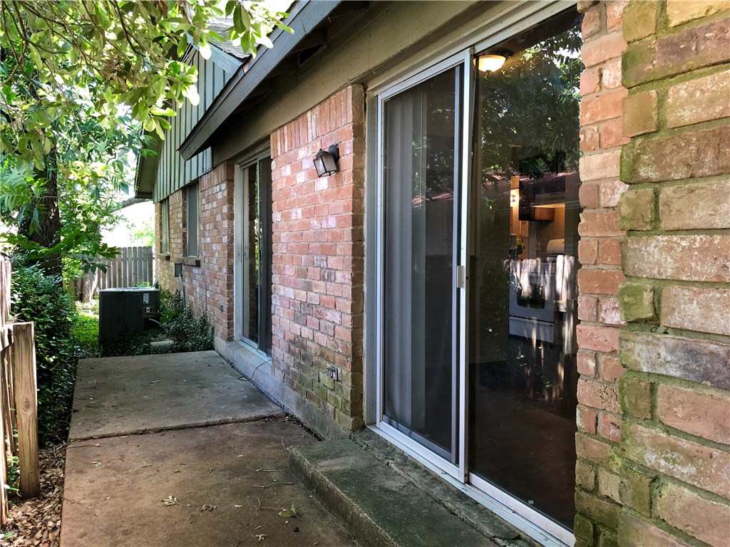 2400 Berkeley Avenue, Unit B Austin, TX 78745 - Photo 3 of 18 a view of a brick house with a glass door