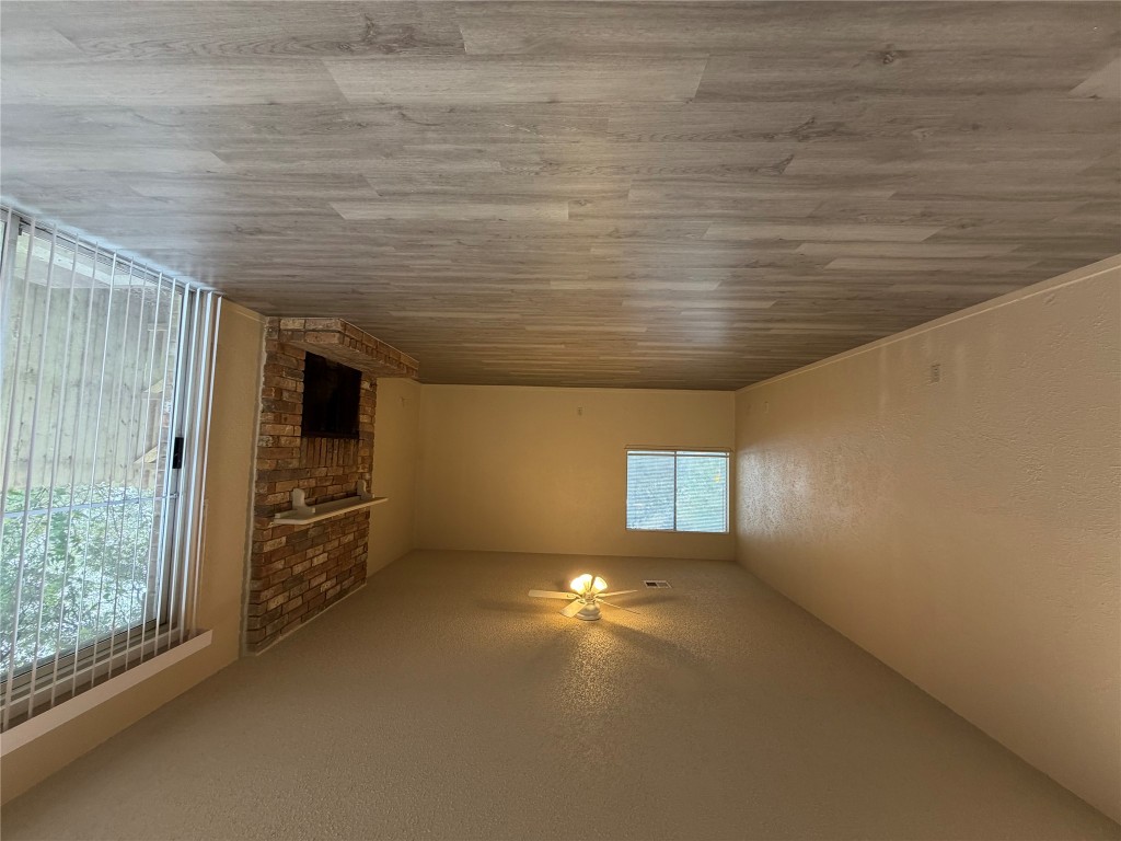 2400 Berkeley Avenue, Unit B Austin, TX 78745 - Photo 7 of 18 an empty room with wooden floor and windows