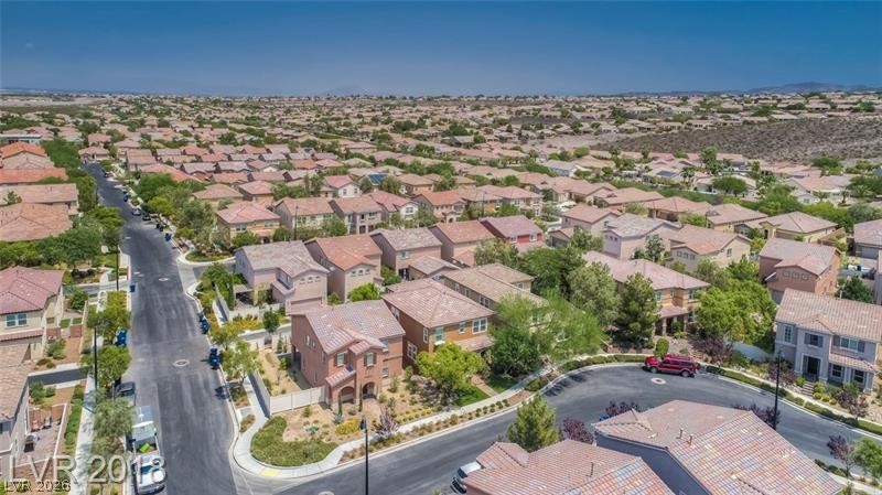 3144 Whitfeild Avenue Henderson, NV 89044 - Photo 40 of 55 An aerial perspective reveals a vast neighborhood of residences with clay tile roofs under a clear blue sky.