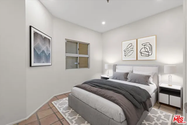 a bedroom with bed and painting on the wall