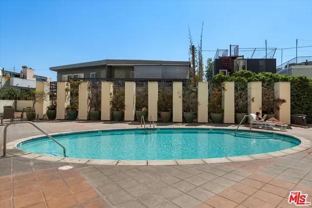 a view of a house with swimming pool and porch