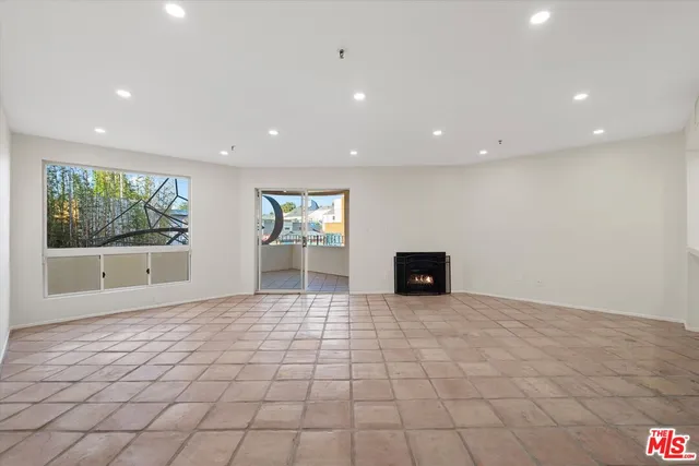 a view of a hallway with wooden floor and a fireplace