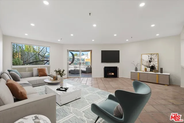 a living room with fireplace furniture and a flat screen tv
