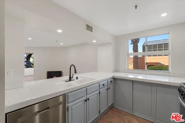 a kitchen with a sink and cabinets