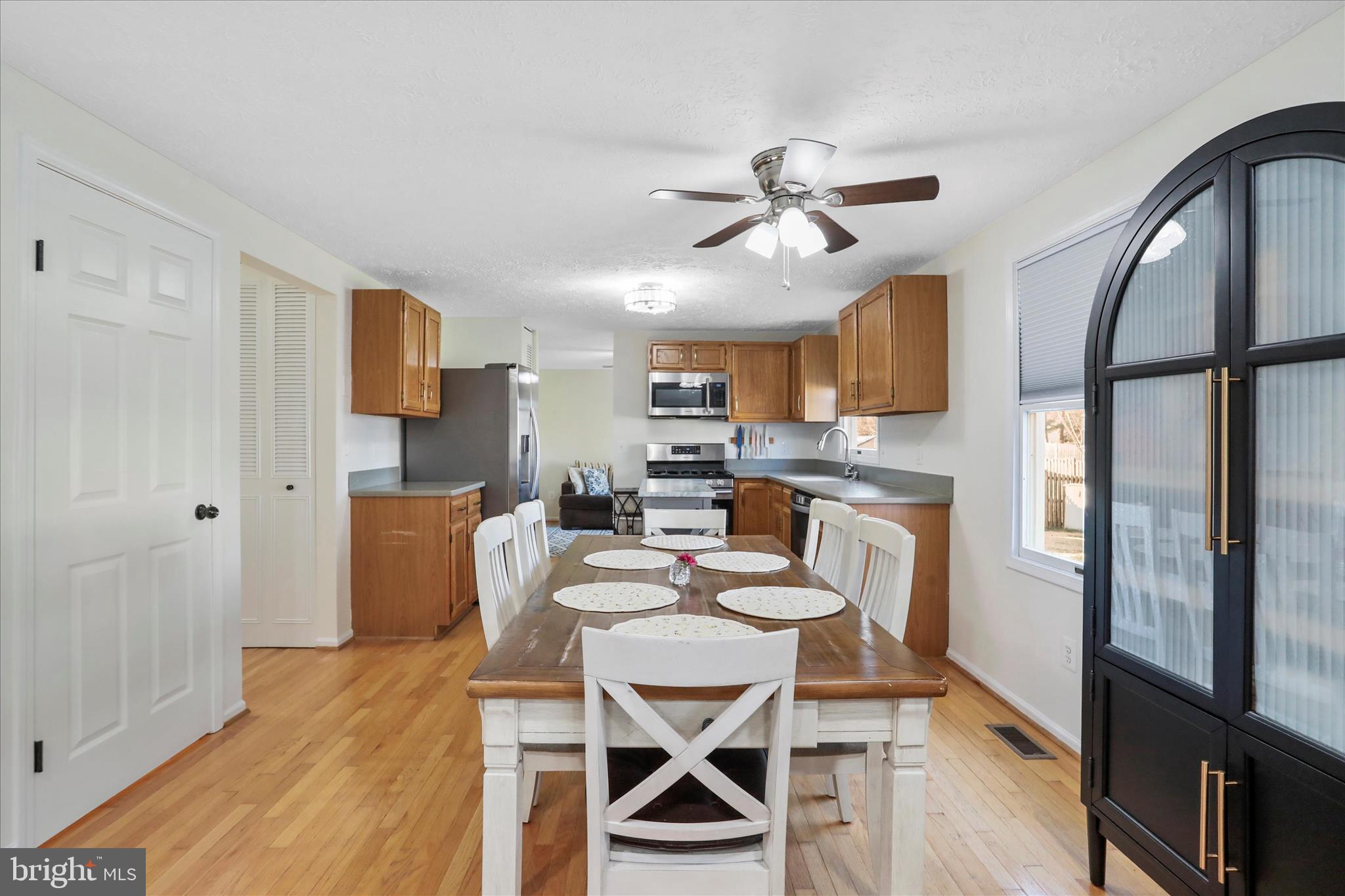 5435 Tree Line Drive Centreville, VA 20120 - Photo 11 of 51 a view of a dining room with furniture a rug and wooden floor