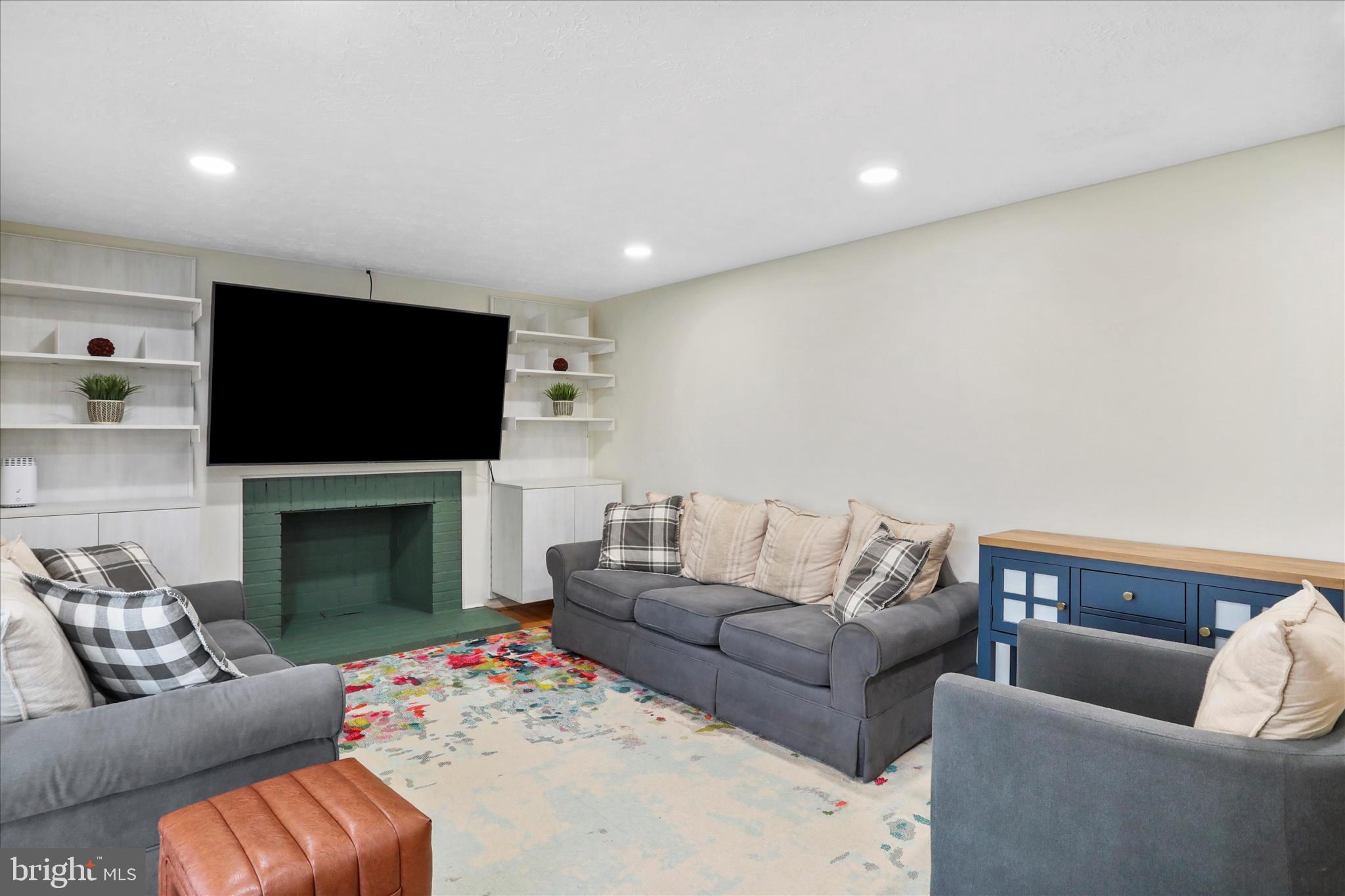 5435 Tree Line Drive Centreville, VA 20120 - Photo 13 of 51 a living room with furniture a fireplace and a flat screen tv