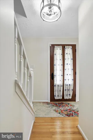 a bedroom with two beds and a chandelier