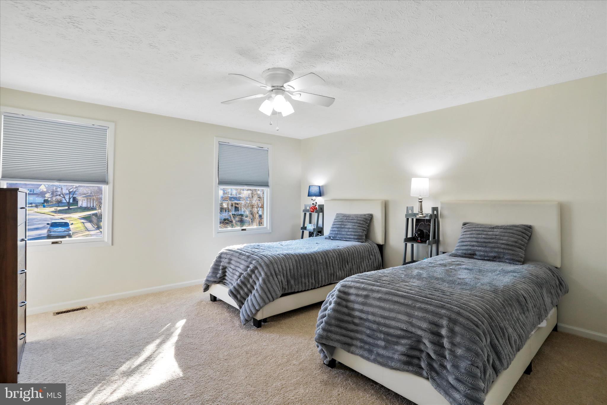 5435 Tree Line Drive Centreville, VA 20120 - Photo 29 of 51 a bedroom with two beds and a chandelier