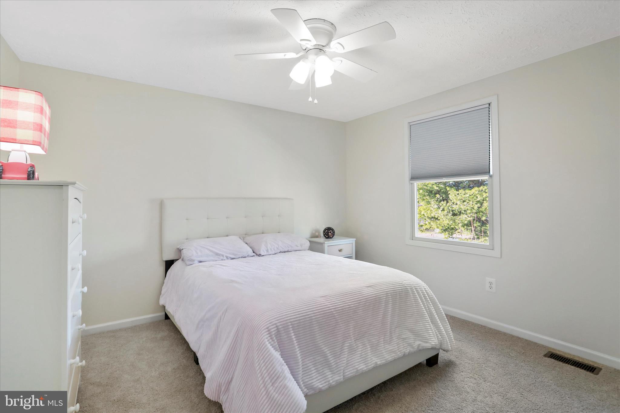 5435 Tree Line Drive Centreville, VA 20120 - Photo 31 of 51 a bedroom with a bed and a chandelier