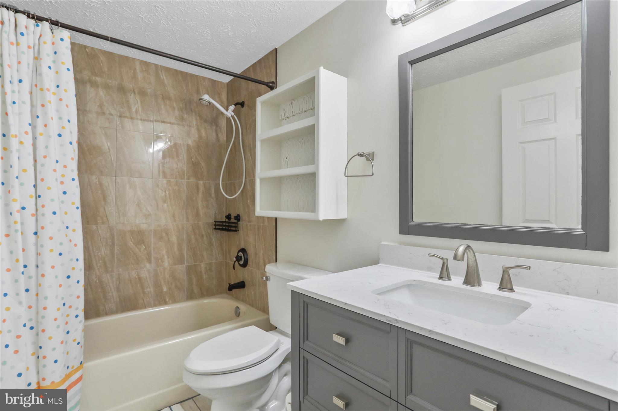 5435 Tree Line Drive Centreville, VA 20120 - Photo 32 of 51 a bathroom with a granite countertop sink toilet and shower