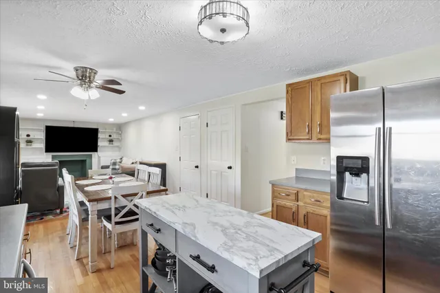 a view of a dining room with furniture a rug and wooden floor