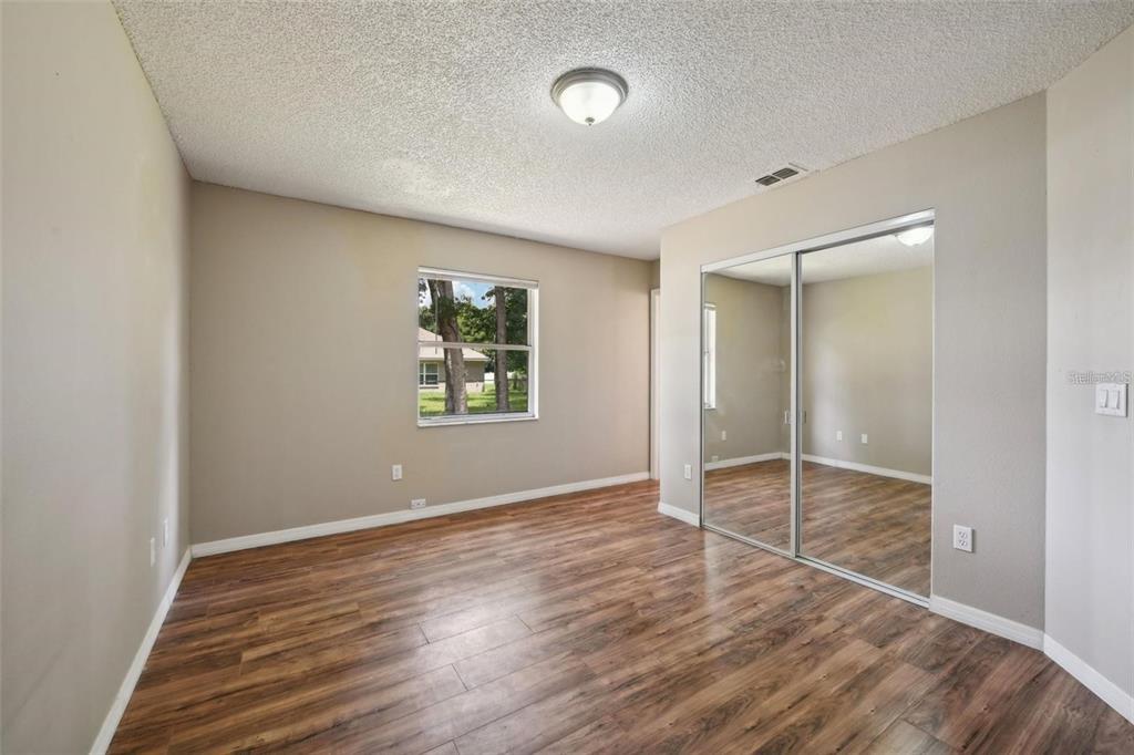 5 Cedar Lane Ocala, FL 34472 - Photo 11 of 23 an empty room with wooden floor and windows