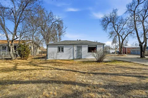 a view of a house with a yard covered in snow