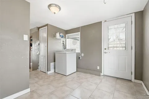 a view of a kitchen with a sink and a refrigerator