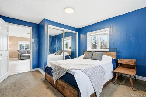 a bedroom with a bed and a dresser