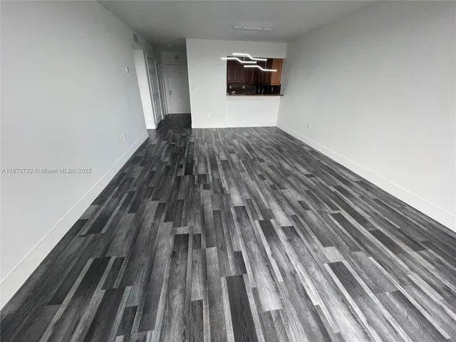 a living room with a bed and a television