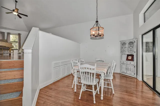 a view of a dining room with furniture wooden floor and a chandelier