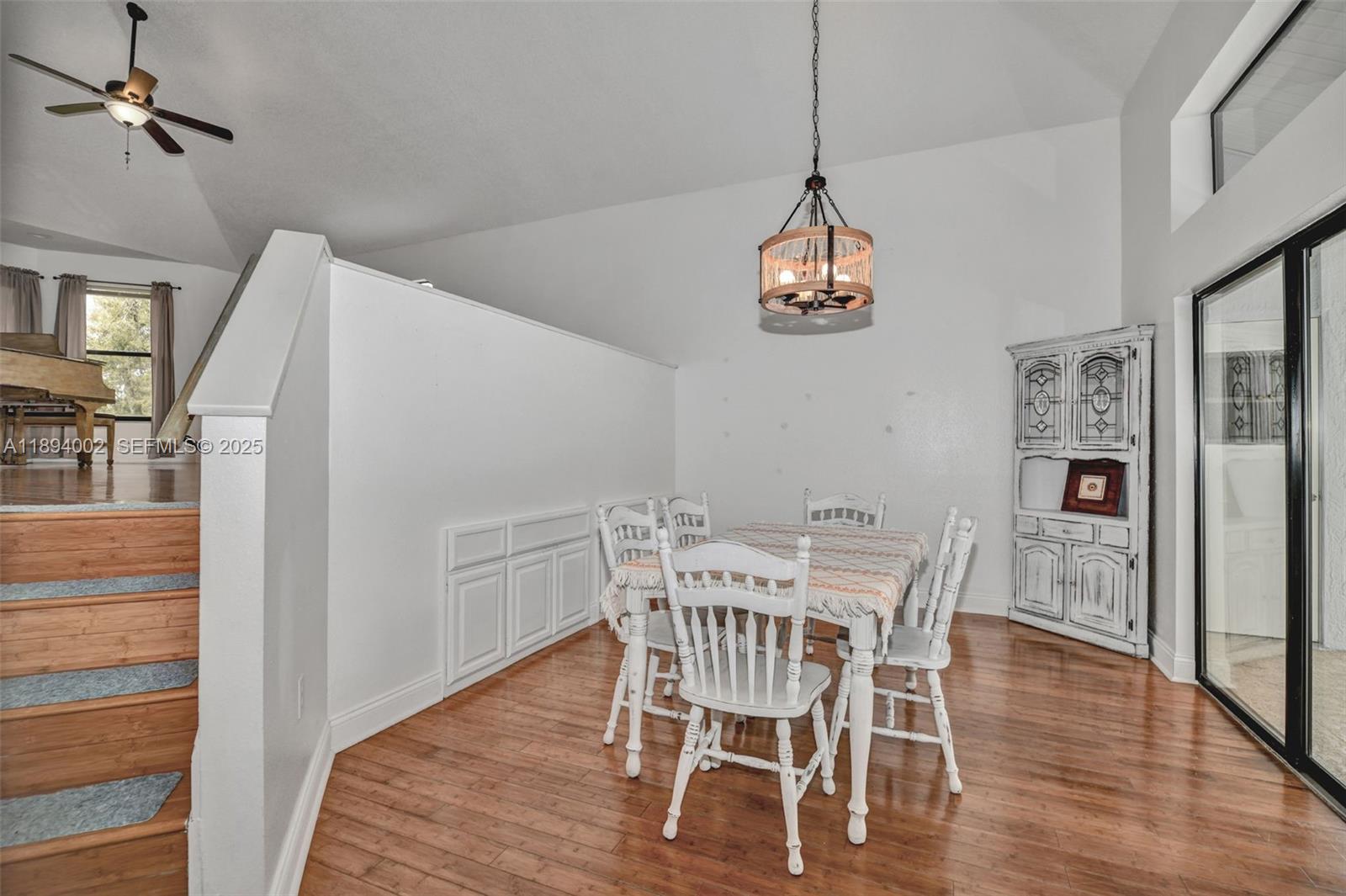 7505 Jomel Drive Spring Hill, FL 34607 - Photo 15 of 44 a view of a dining room with furniture wooden floor and a chandelier