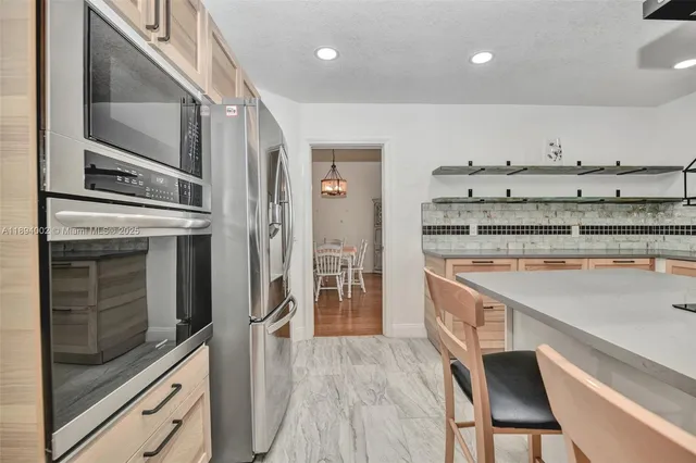 a kitchen with a stove and a refrigerator