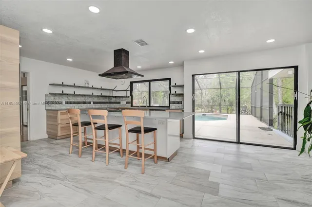 a view of a big room with wooden floor and windows