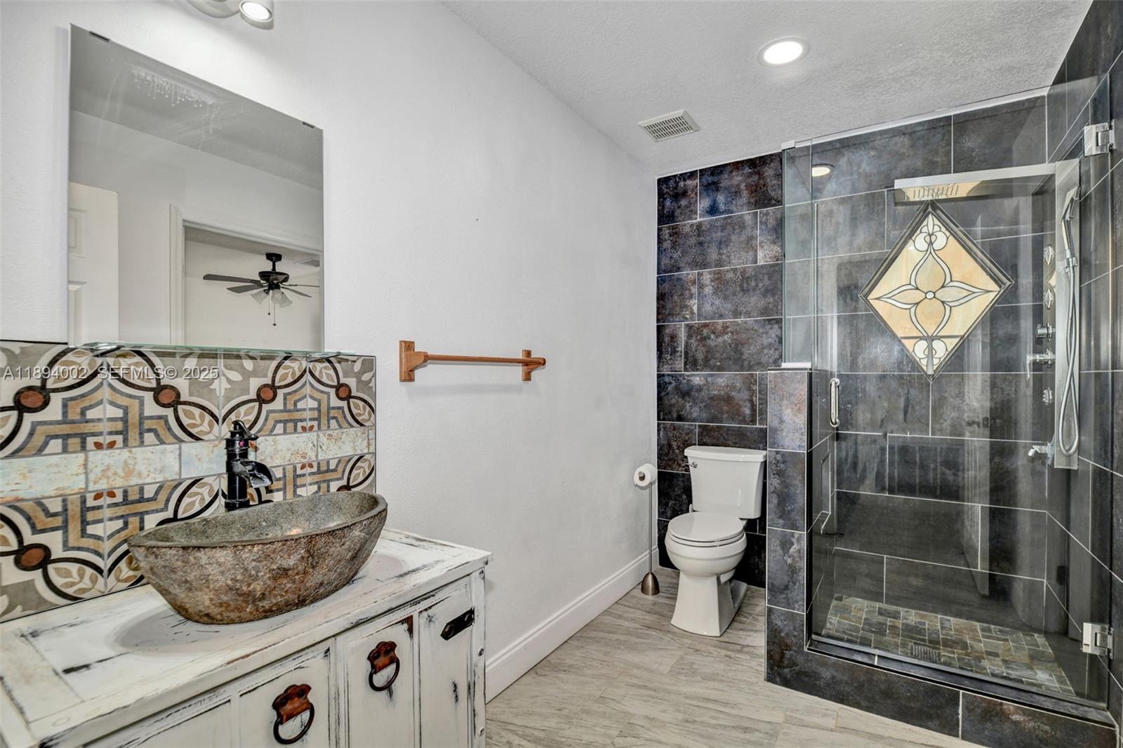 7505 Jomel Drive Spring Hill, FL 34607 - Photo 22 of 44 a bathroom with a shower and a toilet