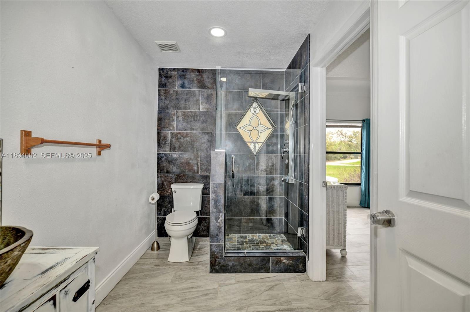 7505 Jomel Drive Spring Hill, FL 34607 - Photo 23 of 44 a bathroom with a shower and a toilet