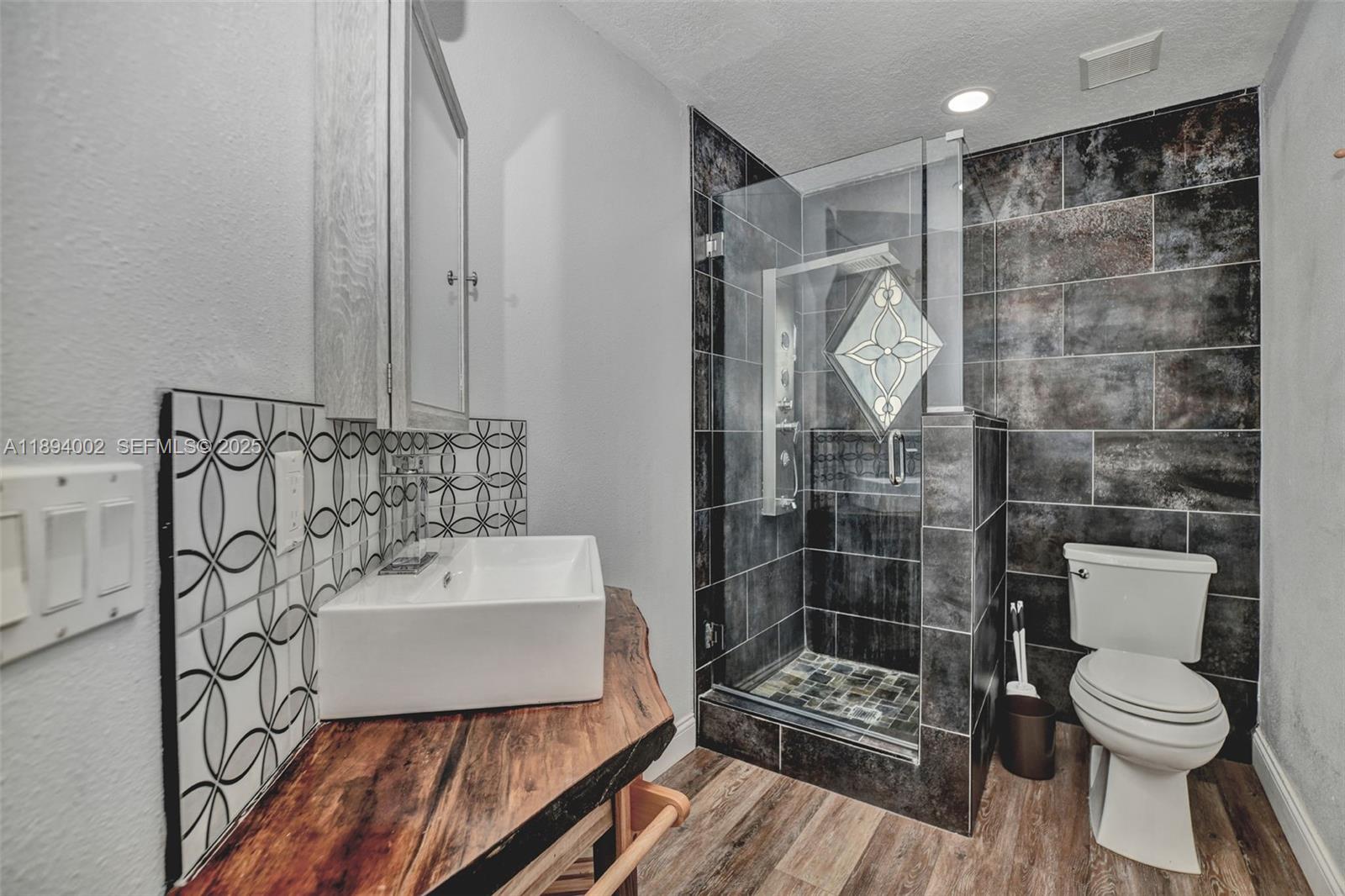 7505 Jomel Drive Spring Hill, FL 34607 - Photo 27 of 44 a bathroom with a sink toilet and shower