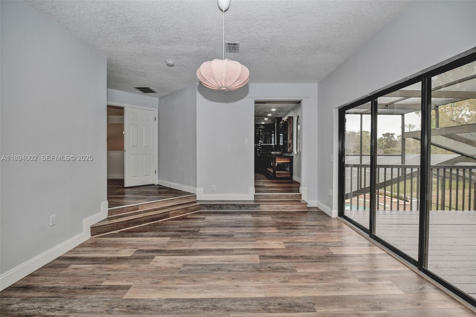 7505 Jomel Drive Spring Hill, FL 34607 - Photo 29 of 44 a view of a room with wooden floor and balcony