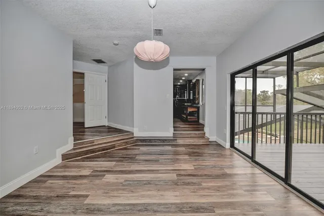 a view of a room with wooden floor and balcony