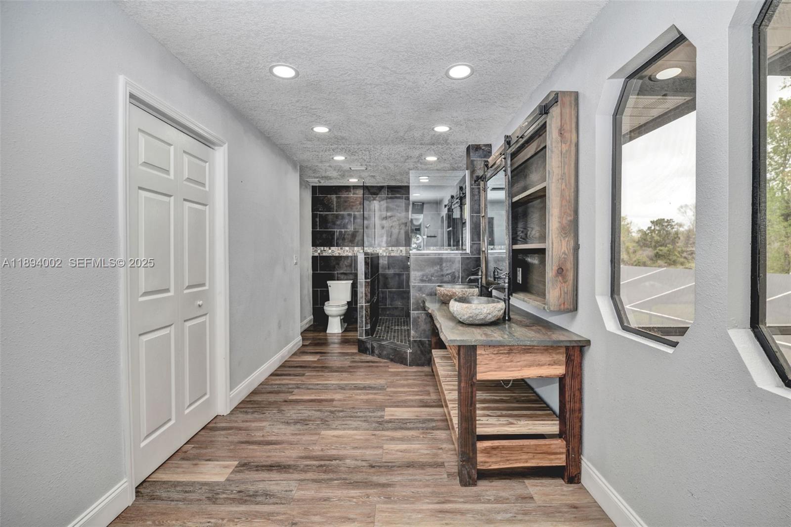 7505 Jomel Drive Spring Hill, FL 34607 - Photo 30 of 44 a view of a hallway with wooden floor and entryway